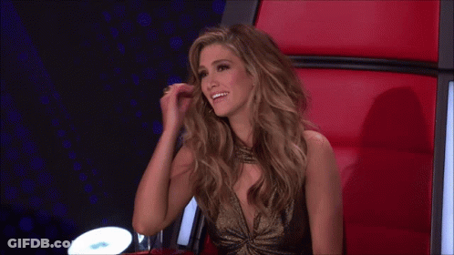 Woman In Gold Dress Sitting On Red Chair GIF