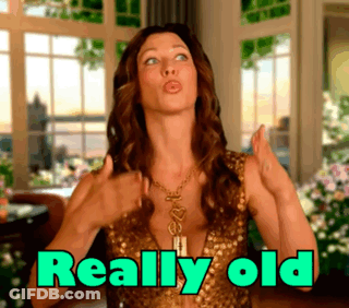 Woman In Gold Dress Thumbs Up Saying Really Old GIF