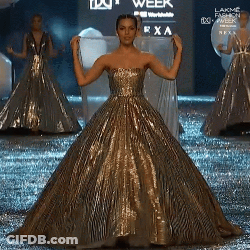 Woman In Gold Dress Walking At Lakme Fashion Week GIF