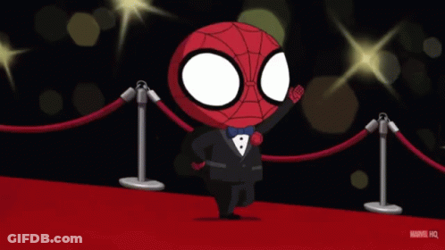Woman In Gold Dress Walking Red Carpet With Man In Tuxedo GIF