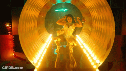 Woman In Gold Outfit In Tunnel With Lights GIF