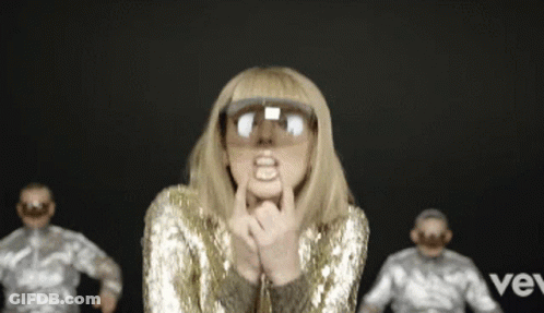 Woman In Gold Sequined Jacket Sunglasses Funny Face GIF