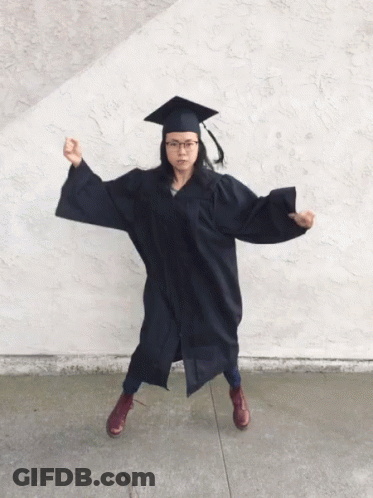 Woman In Graduation Cap And Gown Flexing GIF