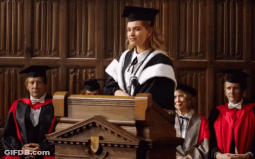 Woman In Graduation Cap And Gown Giving Speech GIF