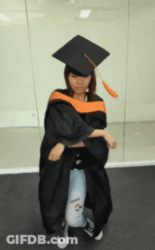 Woman In Graduation Cap And Gown Kneeling GIF