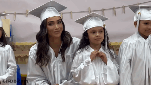 Woman In Graduation Cap And Gown Next To Girl GIF