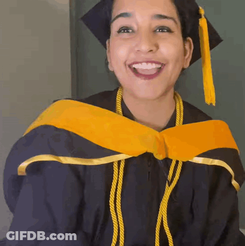 Woman In Graduation Cap And Gown Smiling GIF