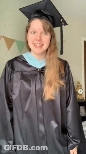 Woman In Graduation Cap And Gown Smiling GIF