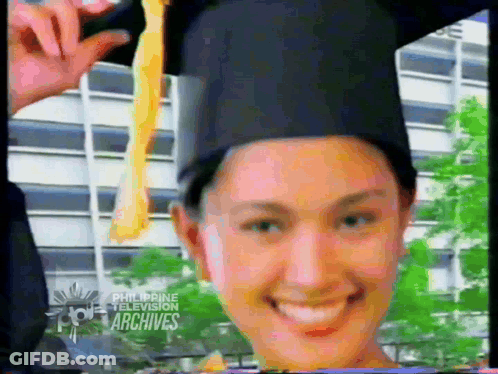Woman In Graduation Cap And Gown Smiling GIF