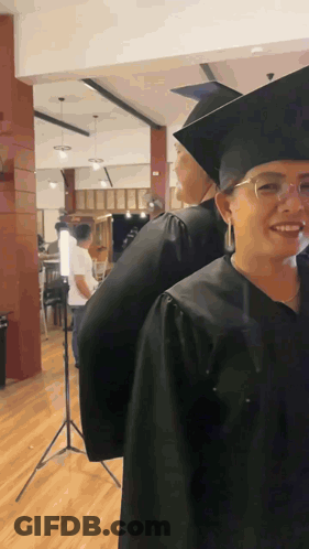 Woman In Graduation Cap And Gown Smiling GIF