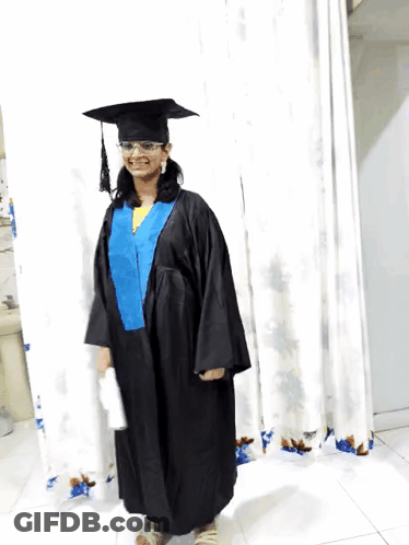 Woman In Graduation Cap And Gown Smiling GIF