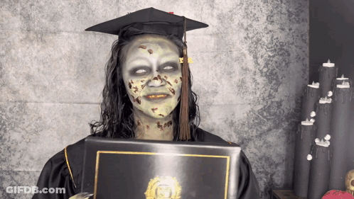 Woman In Graduation Cap And Gown With Zombie Makeup GIF