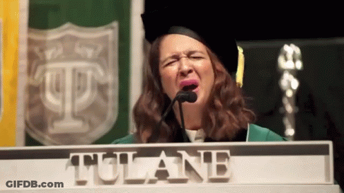 Woman In Graduation Cap Behind Tulane Podium GIF