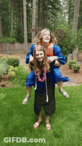 Woman In Graduation Gown Carrying Another Woman GIF
