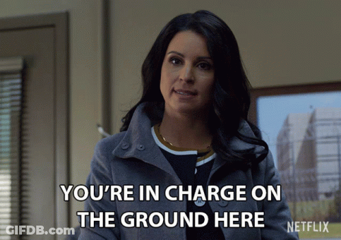 Woman In Gray Coat Says You're In Charge On The Ground Here GIF