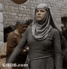 Woman In Gray Dress And Head Scarf GIF