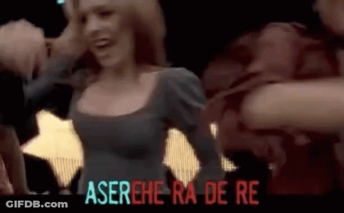 Woman In Gray Dress Dancing In Front Of Aserehe Ra De Re Sign GIF