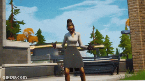 Woman In Gray Dress In Front Of Brick Building GIF