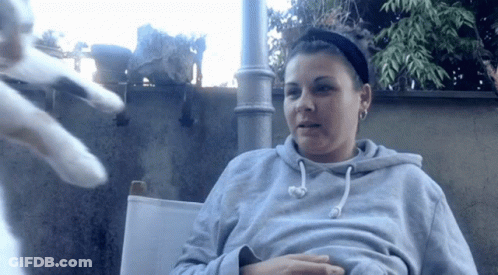 Woman In Gray Hoodie Sitting In Chair GIF