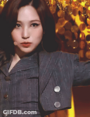 Woman In Gray Jacket With White Sleeve Buttons GIF