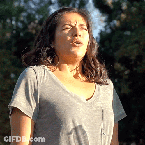 Woman In Gray Shirt With Eyes Closed GIF