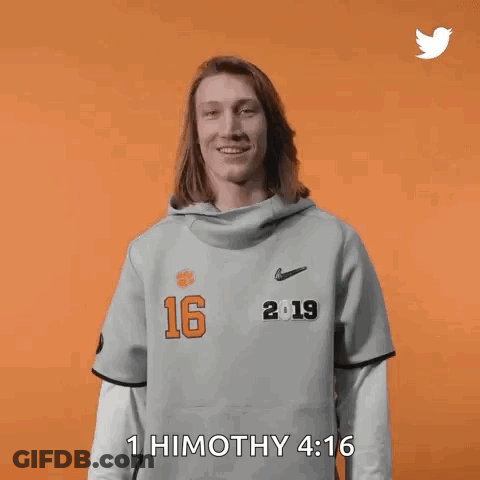 Woman In Gray Shirt With Number 16 Holding Hair GIF