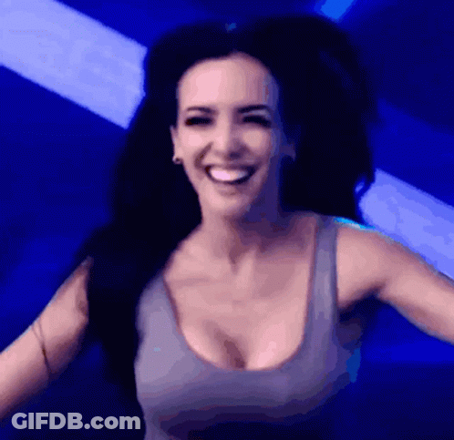 Woman In Gray Tank Top Smiling In Blue Light GIF