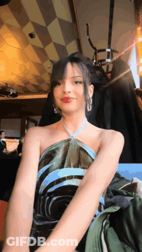 Woman In Green And Blue Dress Sitting In Chair GIF