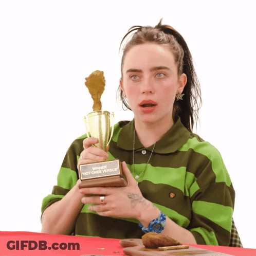 Woman In Green And Brown Striped Shirt Holding Winner Trophy GIF
