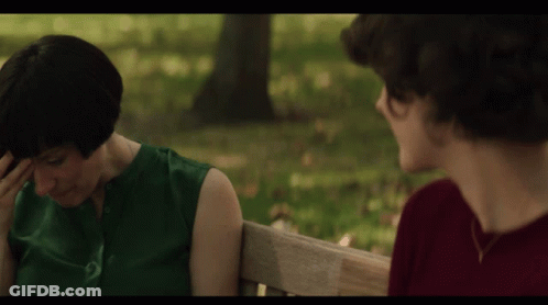 Woman In Green And Man In Red On Bench GIF