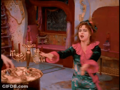 Woman In Green And Pink Dress Dancing By Candelabra GIF