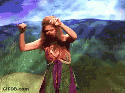 Woman In Green And Purple Dress Dancing By Mountain GIF