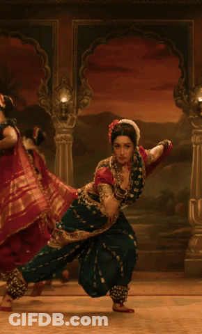 Woman In Green And Red Costume Dancing GIF