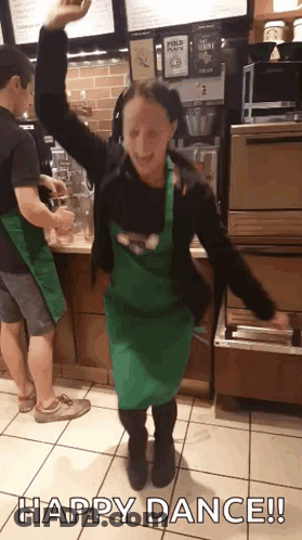 Woman In Green Apron Dancing Happy Dance GIF