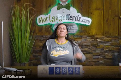 Woman In Green Bay Packers Shirt In Front Of Mortgage Nerds Sign GIF