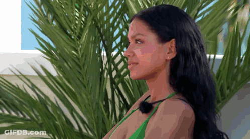 Woman In Green Bikini Smiling In Front Of Palm Tree GIF