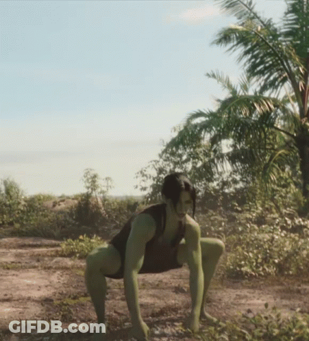 Woman In Green Bodysuit Squatting In Dirt GIF