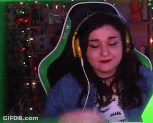 Woman In Green Chair With Headphones And Letter M GIF