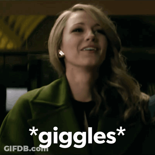 Woman In Green Coat Smiling Giggles GIF