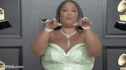 Woman In Green Dress And Necklace Giving Kiss GIF