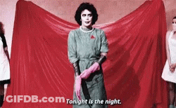 Woman In Green Dress And Pink Gloves Holding Knife GIF