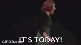 Woman In Green Dress Arms Outstretched Saying It's Today GIF