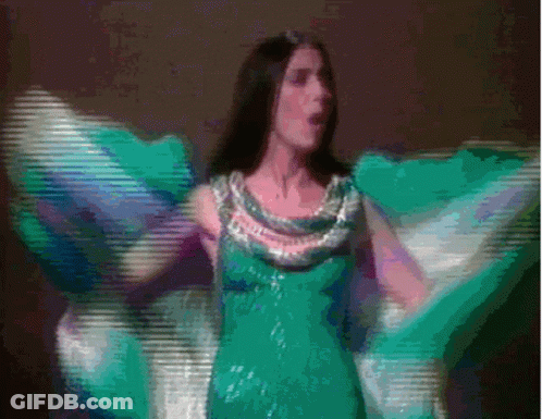 Woman In Green Dress Dancing With Wings Outstretched GIF