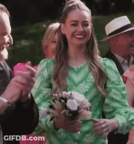 Woman In Green Dress Holding Flowers GIF