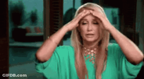 Woman In Green Dress Holding Head GIF