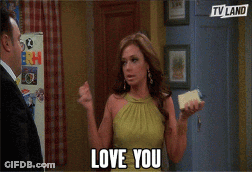Woman In Green Dress Holding Phone Saying Love You GIF