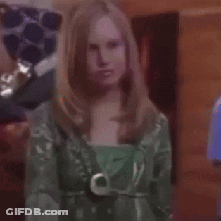 Woman In Green Dress Holding Purple Object GIF