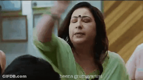 Woman In Green Dress Making Funny Face GIF