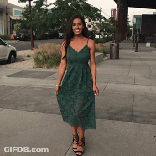 Woman In Green Dress On Sidewalk GIF