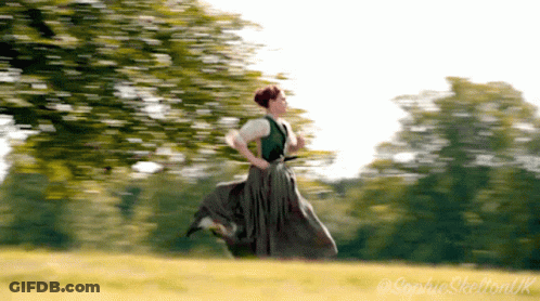 Woman In Green Dress Running Across Field GIF